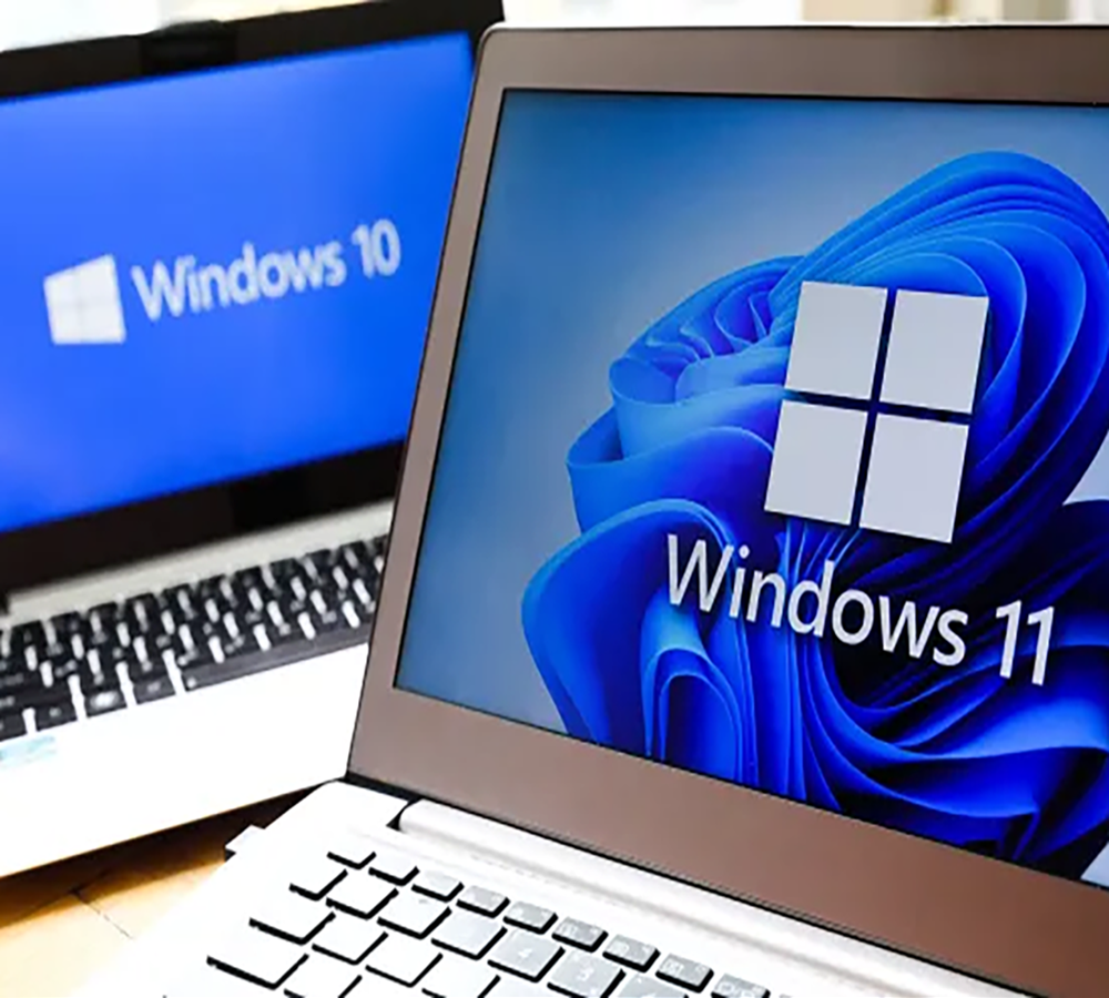 Windows 10 and Windows 11 laptops on a desk